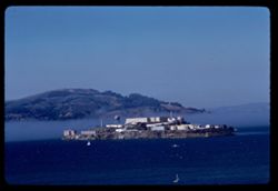 Fog moves between Angel Island and Alcatraz in San Francisco Bay.