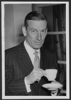 Hoagy Carmichael standing with coffee cup.