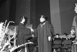 President John Ryan shakes hands with graduate at Commencement, 1980
