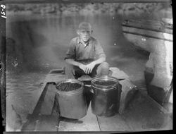 Boy in boat with blackberries, High Bridge, Kentucky
