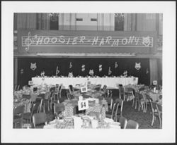 Banquet table and banner reading "Hoosier Harmony."