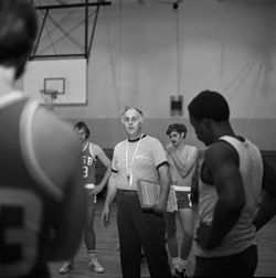 IU South Bend men's basketball coach instructs team, 1970s