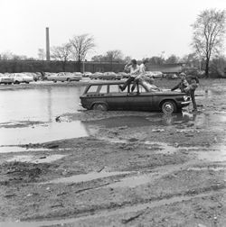 Students in flooded parking lot at IU South Bend, 1970s