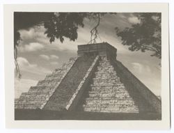 Item 0152. Various similar views of the Castillo, some with trees and/or other foliage visible. Tree branches around top and upper sides of photo. One bare branch hangs down directly over top of Castillo.