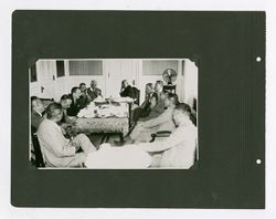 Roy W. Howard and acquaintances at a meeting