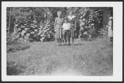 Nara Helton, Ellen and Don Young, Jr. posing in yard during a Robison family reunion at house on 3120 Graceland Avenue, Indianapolis, Indiana.
