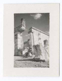 Item 0771 - 0773. Various shots of the Chac-Mool in front of the entrance to the upper temple of the Temple of the Warriors. Shots of young Indigenous person sitting in front of serpent's heads. See Item 169 above.
