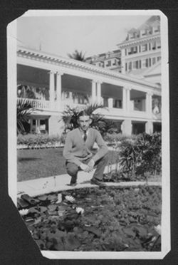 Hoagy Carmichael squatting by a pond at the Poinciana Hotel, Florida, ca. 1925.