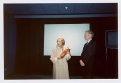 Elisabeth Welch holding BFHFI induction plaque beside unidentified man