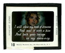 Song-hit slide: I will close my book of dreams / And seal it with a kiss...