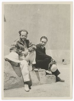 Item 0399. Eisenstein and Salvador Baguez seated on steps in the Hacienda courtyard.