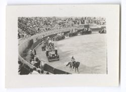 Item 0611. Shots of parade of automobiles around arena. Long shot, taken from upper stands. Parade approaching camera.
