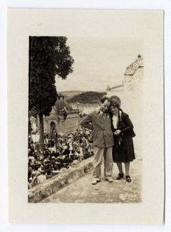 Item 1166. - 1166a. Two views of Eisenstein and unidentified woman on roof or balcony above crowd gathered in front of decorated church (not the same site as in Items 1165-1165a above).
