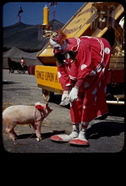 Clown Felix Adler and bottle fed pig