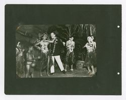 Roy W. Howard dancing with Hula dancers