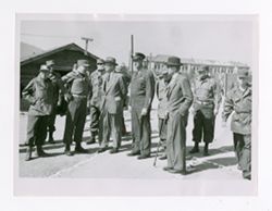 Roy Howard standing with military personnel