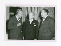 Roy Howard talking with two men