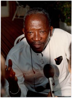 Ousmane Sembène speaking into handheld microphone