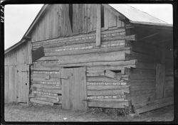 Log barn with auto license plates on cracks, n.e. of Martinsville