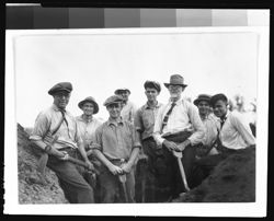 Eight males with shovels and pickaxes