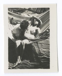 Item 0598. - 0603.Various shots of young couple lying in a hammock hung beneath palm trees at the edge 603 of a bench (?)
