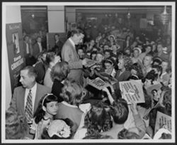 Crowd in Portland, Oregon handing records to Hoagy Carmichael to sign.