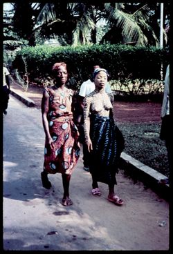 A woman in tribal dress strolls down Payne Avenue