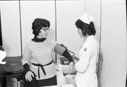 IU South Bend dental hygiene student takes blood pressure, 1976