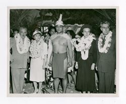 Roy Howard and other white people wearing leis