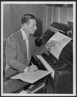 Hoagy Carmichael composing in the den of his Los Angeles home.