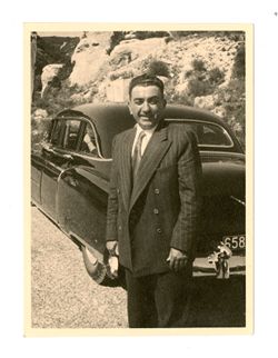 Man posing with automobile