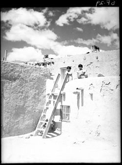Family ascending ladder, meat out to dry, Acoma