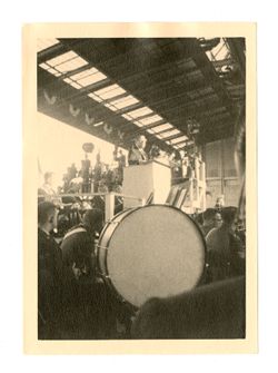 Man at podium with band in front
