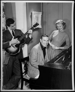 Hoagy Carmichael playing piano, with an unidentified man playing guitar and an unidentified woman.