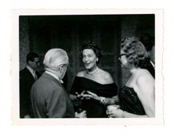 Roy Howard talking with two women