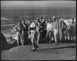 Hoagy Carmichael in bow tie among a group of spectators,including Dutch Harris (left of Carmichael) and Jimmy Thompson (right), watching Phil Harris hit a golf shot.