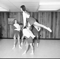 IU South Bend cheerleaders practicing lifts, 1970s