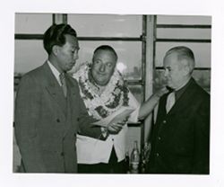 Roy Howard greeted by other men