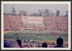 Crowd at Rose Bowl, IU vs. USC, holding cards that spell out "Indiana," band on field.
