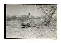 Roy Howard poses with rhinoceros carcass