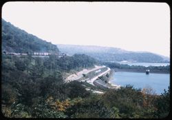 Penna. freight downbound on left side of Horseshoe Curve. Reservoir at right.