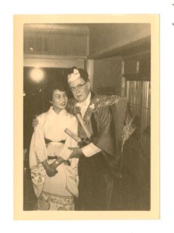 Roy Howard standing with a young woman in a "Japanese" costume