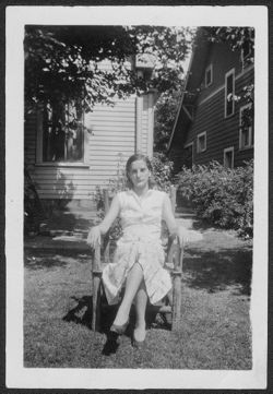 Martha Carmichael sitting in lounge chair in front yard.