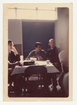 Cesar Chavez seated at the head of the table