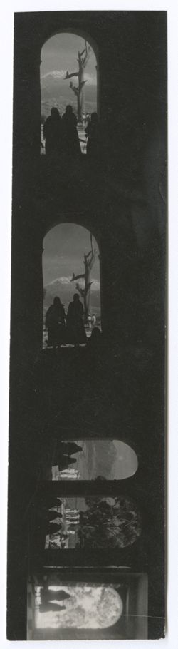 Item 0254. Three strips of contact prints with scenes of various women seen in silhouette in archways, with mountains visible in the far distance. Three (?) prints on a strip.