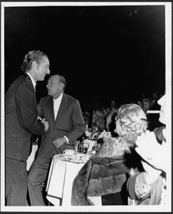 Hoagy Carmichael shaking hands with Leonard Feather at an Indiana University Alumni Association event honoring Carmichael, Hollywood.