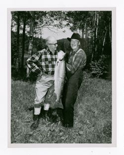 Roy Howard and another man posing with fish