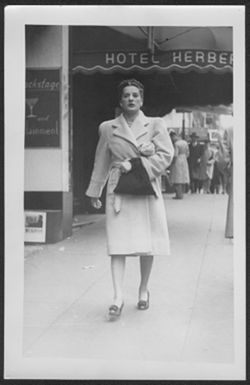 Martha Carmichael walking down city street.