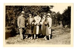 Group standing in an orange grove