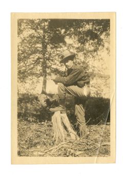 Roy Howard posing with a tree stump